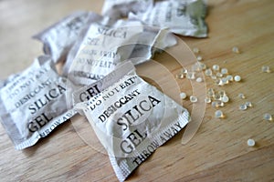 Silica gel packets on a wooden surface