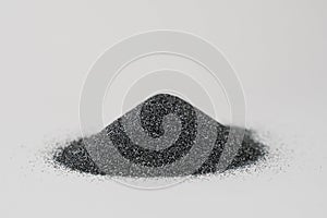 Silicon carbide powder close-up isolated on white background. Silicon carbide abrasive grit for restore stones to