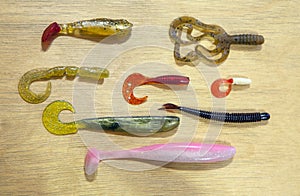 Silicon fishing bait wooden background