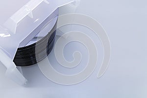 Silicon wafer inspection. A batch of silicon wafers packed in a plastic storage box in the clean room of a semiconductor