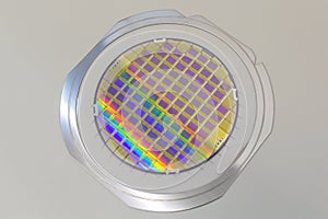 Silicon wafer with microchips fixed in the holder with steel frame on the grey background and ready for process