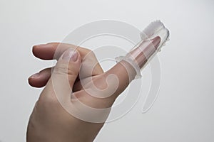 Silicone brush for brushing babies` teeth, put on mother`s finger