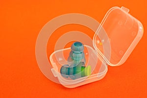 Silicone ear plugs for human ears on red background