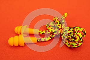 Silicone ear plugs for human ears on red background