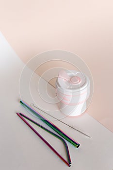 Silicone straw cup with stainless steel straws in ligtht background. photo