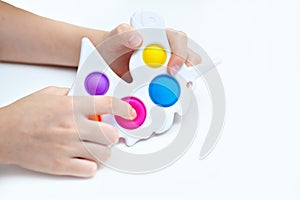 Silicone toy antistress in the hands of a teenager. Anti-stress colorful toy. New trend. Colorful anti stress sensory