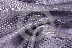 Silk background, texture of violet, diamond patern shiny fabric