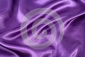 Silk background, texture of violet shiny fabric