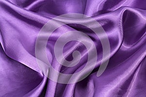 Silk background, texture of violet shiny fabric