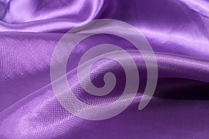 Silk background, texture of violet shiny fabric