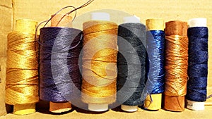 Silk and cotton threads for sewing and embroidery. Spools with multi-colored threads.