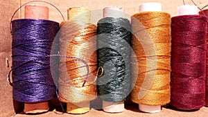 Silk and cotton threads for sewing and embroidery. Spools with multi-colored threads.