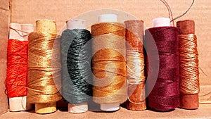 Silk and cotton threads for sewing and embroidery. Spools with multi-colored threads.