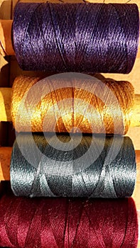 Silk and cotton threads for sewing and embroidery. Spools with multi-colored threads.