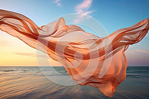 Silk fabric develops in the wind against the background of the sea and sky