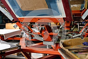 Silk screen textile printery. print screening apparatus. serigraph printing production photo
