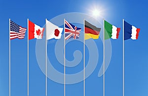 Silk waving G7 flags of countries of Group of Seven Canada, Germany, Italy, France, Japan, USA states, United Kingdom. Blue sky