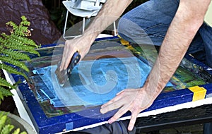 Silkscreening hand with squeegee