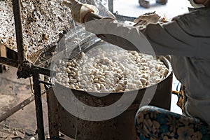 Silkworm cocoon is boilling and unwinding by Vietnamese worman to make silk thread at village in Nam Dinh province, Vietnam