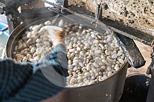 Silkworm cocoon is boilling and unwinding by Vietnamese worman to make silk thread at village in Nam Dinh province, Vietnam