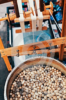 Silkworm cocoons in hot water in cauldron