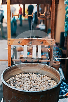 Silkworm cocoons in hot water in cauldron