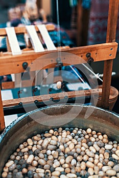 Silkworm cocoons in hot water in cauldron