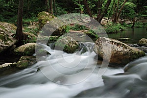 Silky river flow near waterfall known as Santa Margarida