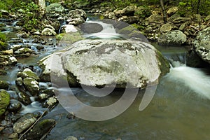 Silky Water falling over Moss Covered Rocks Wide Shot