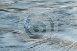Silky water surface detail from rapid mountain stream in long exposure
