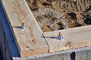 Sill plate on concrete foundation anchors.