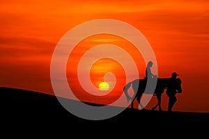 Sillhouette of a journey on horseback photo