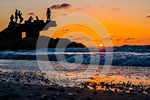 Sillhouette of people in the beach during sunset