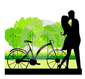 Sillhouette of sweet young couple in love standing in the park