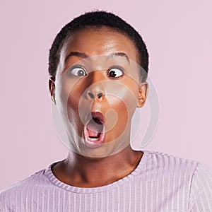 Silliness for the soul. Studio shot of a young woman making a silly face against a pink background.