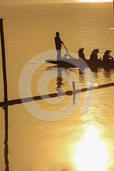 Sillouette of mans padding on lake photo