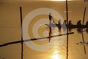 Sillouette of mans padding on lake photo