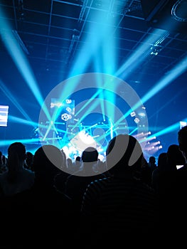 Sillouettes of spectators on a concert photo