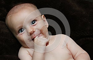 Silly funny big eyed laughing smiling baby