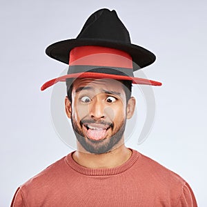 Silly, hats and goofy man in a studio with a crazy, funny and comic face expression or pose. Comedy, happy and Mexican
