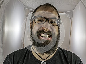 A silly looking bearded man with glasses