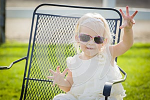Silly Playful Toddler Girl Wearing Sunglasses Outside at Park