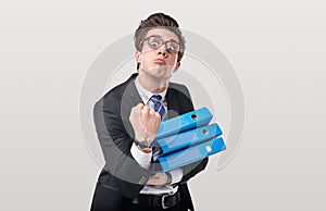 Silly worker with folders threatening with fist