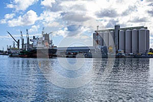 Silo and cargo ship at the harbor of Port Louis, Mauritius.