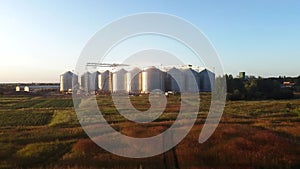 Silo tanker storages in the field with sunset light