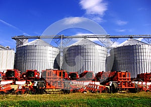 Silos and agricultural machinery photo