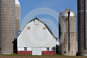 Silos and a barn against blue sky in rural United States