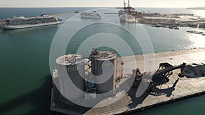 Silos for bulk storage at the Malaga Port, Andalusia, Spain. Cruise ship docked at terminal