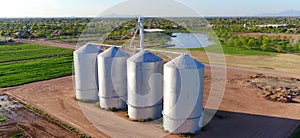 4 Silos by a Field - Aerial Point of View