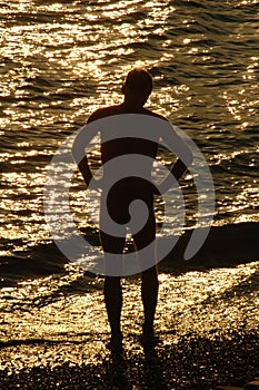 Silouette of a man in front of sea photo